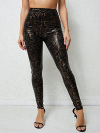 Damen Hochglänzende Leggings im Schlangenmuster in Gold