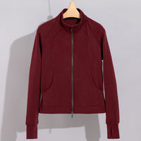 Damen Performance-Trainingsjacke mit Stehkragen und Daumenloch Nord Taschen in Bordeauxrotes Oberteil